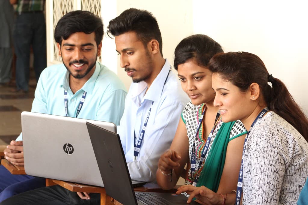 BCA students collaborating with laptops at BIHE Davangere